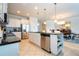 Open concept kitchen with island, stainless steel appliances and white cabinets at 8841 Rhodes St, Kissimmee, FL 34747