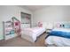 Charming bedroom with twin beds, a dresser, and built in shelving at 8841 Rhodes St, Kissimmee, FL 34747