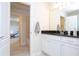 Bathroom with white cabinets, dark countertop and a view of another room at 8841 Rhodes St, Kissimmee, FL 34747