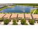 Aerial view of community, lake, and several homes with tile roofs at 8841 Rhodes St, Kissimmee, FL 34747