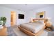 Main bedroom with wood bed frame and en-suite bathroom at 4278 Green Gables Pl, Kissimmee, FL 34746