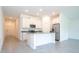 Open concept kitchen with island, stainless steel appliances, and white cabinets at 4278 Green Gables Pl, Kissimmee, FL 34746