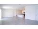 Open living room with kitchen island and gray tile floors at 4278 Green Gables Pl, Kissimmee, FL 34746