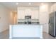 Open concept kitchen with island, stainless steel appliances, and white cabinets at 4278 Green Gables Pl, Kissimmee, FL 34746