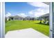 Home with grassy backyard, patio, and neighboring houses visible at 4278 Green Gables Pl, Kissimmee, FL 34746