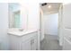 Simple bathroom with white vanity and mirror, near additional rooms at 4278 Green Gables Pl, Kissimmee, FL 34746