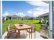 Outdoor patio with seating area and grill, overlooking grassy backyard at 4278 Green Gables Pl, Kissimmee, FL 34746