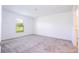 Bright bedroom with gray carpeting and a window offering natural light at 4278 Green Gables Pl, Kissimmee, FL 34746
