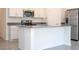 White kitchen island with grey countertop, offering extra prep space at 4278 Green Gables Pl, Kissimmee, FL 34746