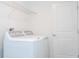 Bright laundry room with washer, dryer, and overhead shelving at 4278 Green Gables Pl, Kissimmee, FL 34746