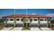 Three-unit townhome building with modern design and attached garages at 1815 Brentwood Ct, Davenport, FL 33837