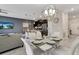 Open concept dining area with modern table and chairs, adjacent to kitchen and living room at 4838 Romeo Cir, Kissimmee, FL 34746