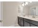 Double vanity bathroom with modern fixtures and a large mirror at 4838 Romeo Cir, Kissimmee, FL 34746