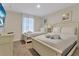 Two beds, nightstands, and a dresser in a well-lit bedroom at 4838 Romeo Cir, Kissimmee, FL 34746