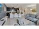 Modern kitchen with island and breakfast bar, open to living and dining areas at 4838 Romeo Cir, Kissimmee, FL 34746