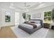 Main bedroom with hardwood floors, gray bed, and ensuite bathroom at 1840 Biscayne Dr, Winter Park, FL 32789