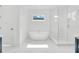 Spa-like bathroom featuring a soaking tub, glass shower, and marble tile at 1840 Biscayne Dr, Winter Park, FL 32789