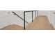 Modern staircase with black metal railing and light hardwood floors at 1840 Biscayne Dr, Winter Park, FL 32789
