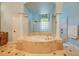 Large bathroom with soaking tub, walk-in shower, and tile floor at 10527 Emerald Chase Dr, Orlando, FL 32836