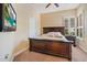 Guest bedroom with a king-size bed and window seat at 10527 Emerald Chase Dr, Orlando, FL 32836