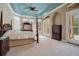 Main bedroom with four-poster bed, and access to backyard at 10527 Emerald Chase Dr, Orlando, FL 32836