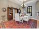 Formal dining room with a chandelier and rich hardwood floors at 10527 Emerald Chase Dr, Orlando, FL 32836