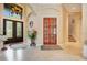 Elegant entryway with double doors and a grand staircase at 10527 Emerald Chase Dr, Orlando, FL 32836