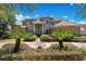 Two-story house with tile roof, landscaping, and a long driveway at 10527 Emerald Chase Dr, Orlando, FL 32836
