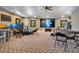 Spacious game room with a projector, poker table, and workspace at 10527 Emerald Chase Dr, Orlando, FL 32836