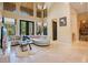 Bright living room with high ceilings, large windows, and comfortable seating at 10527 Emerald Chase Dr, Orlando, FL 32836