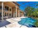 Inviting pool area with covered patio, lush landscaping, and outdoor kitchen at 10527 Emerald Chase Dr, Orlando, FL 32836