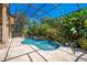 Relaxing screened pool and patio area with tropical landscaping at 10527 Emerald Chase Dr, Orlando, FL 32836