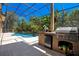 Outdoor kitchen and pool area with screened enclosure and patio at 10527 Emerald Chase Dr, Orlando, FL 32836