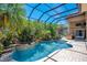 Inviting kidney-shaped pool surrounded by lush landscaping and a spa at 10527 Emerald Chase Dr, Orlando, FL 32836