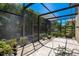 Spacious screened patio with flagstone flooring, plants and lounge chairs at 10527 Emerald Chase Dr, Orlando, FL 32836
