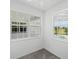 Bedroom with grey carpet and large windows offering pool and nature views at 9313 Quiet Ln, Winter Garden, FL 34787