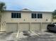 Condo building with four-car garage and parking at 1123 Spring Meadow Dr # 1123, Kissimmee, FL 34741