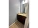 Small half bathroom with granite countertop and dark wood cabinet at 1123 Spring Meadow Dr # 1123, Kissimmee, FL 34741