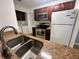 Kitchen with granite counters, stainless steel appliances, and wood cabinets at 1123 Spring Meadow Dr # 1123, Kissimmee, FL 34741