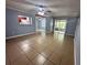 Open living area with tile floors, access to screened porch, and kitchen passthrough at 1123 Spring Meadow Dr # 1123, Kissimmee, FL 34741
