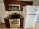Stainless steel appliances and wood cabinets in this well-lit kitchen at 1123 Spring Meadow Dr # 1123, Kissimmee, FL 34741