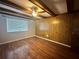 Bedroom with wood-look flooring and wood paneling at 1123 Spring Meadow Dr # 1123, Kissimmee, FL 34741