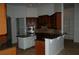 Kitchen with island, dark wood cabinets, and granite counters at 136 Osprey Hammock Trl, Sanford, FL 32771