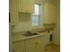 Laundry room with cabinets, sink, and window at 136 Osprey Hammock Trl, Sanford, FL 32771
