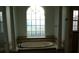 Bathroom boasts a large soaking tub, tile flooring and large window at 136 Osprey Hammock Trl, Sanford, FL 32771