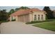 One-story home with tile roof, three car garage and landscaped yard at 136 Osprey Hammock Trl, Sanford, FL 32771