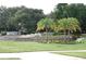 Welcoming community entrance with stonework and landscaping at 136 Osprey Hammock Trl, Sanford, FL 32771