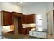 Kitchen with island, dark wood cabinets, and granite countertops at 136 Osprey Hammock Trl, Sanford, FL 32771