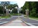 Gated entrance to the community with stone columns at 136 Osprey Hammock Trl, Sanford, FL 32771