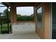 Outdoor kitchen with white cabinets and marble countertops at 136 Osprey Hammock Trl, Sanford, FL 32771